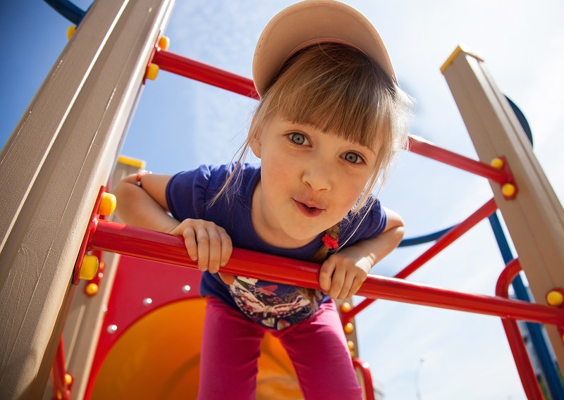 Girl on jungle gym shutterstock 205039507